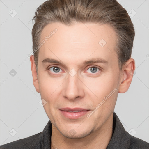 Joyful white adult male with short  brown hair and grey eyes