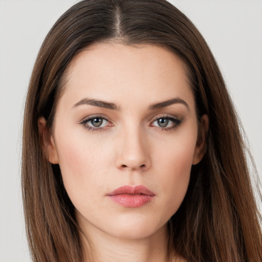 Neutral white young-adult female with long  brown hair and brown eyes