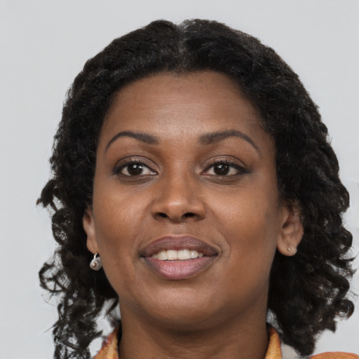 Joyful black young-adult female with medium  brown hair and brown eyes