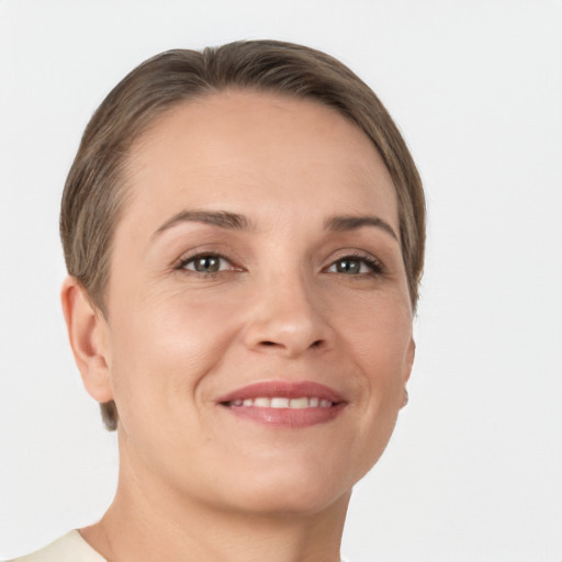 Joyful white young-adult female with short  brown hair and grey eyes