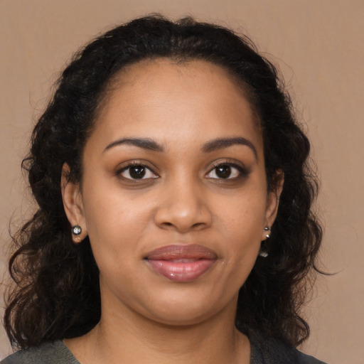 Joyful black young-adult female with medium  brown hair and brown eyes