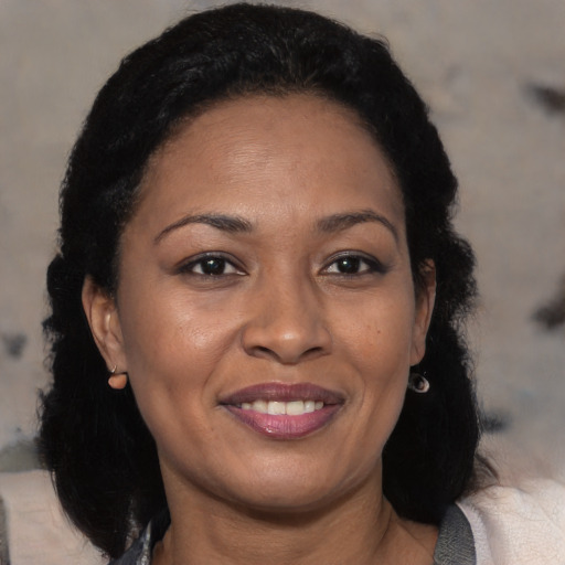 Joyful black adult female with medium  black hair and brown eyes