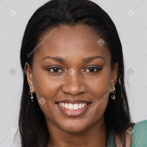 Joyful black young-adult female with long  brown hair and brown eyes