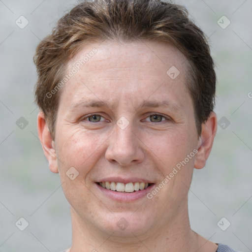 Joyful white adult female with short  brown hair and grey eyes