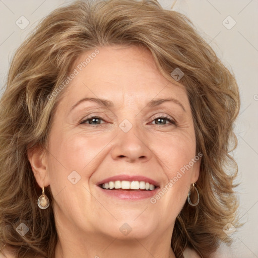 Joyful white adult female with medium  brown hair and green eyes