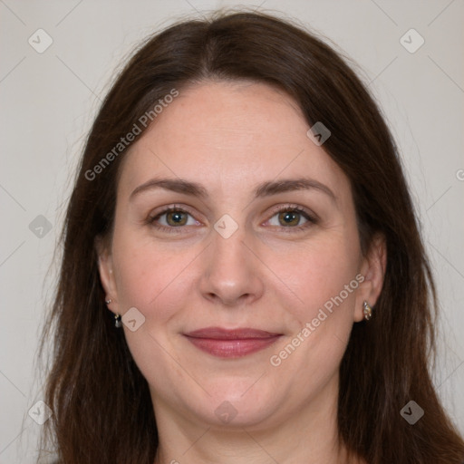 Joyful white adult female with long  brown hair and grey eyes