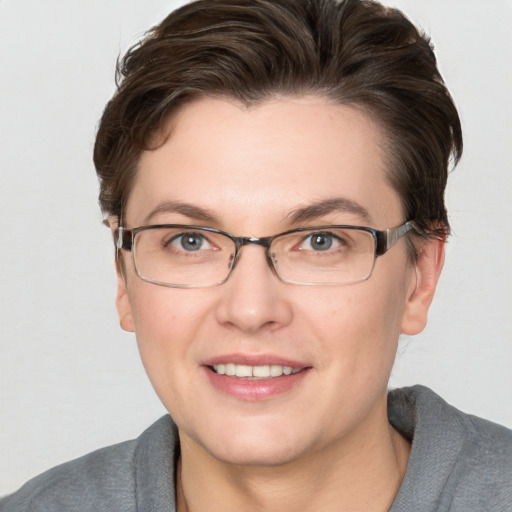 Joyful white young-adult female with short  brown hair and grey eyes