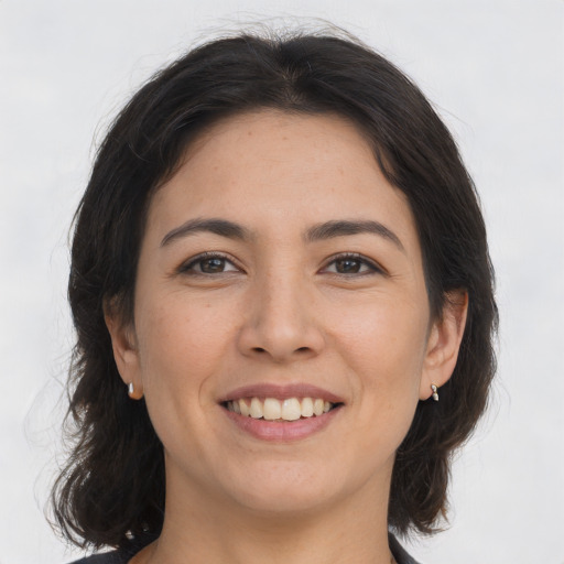 Joyful asian young-adult female with medium  brown hair and brown eyes