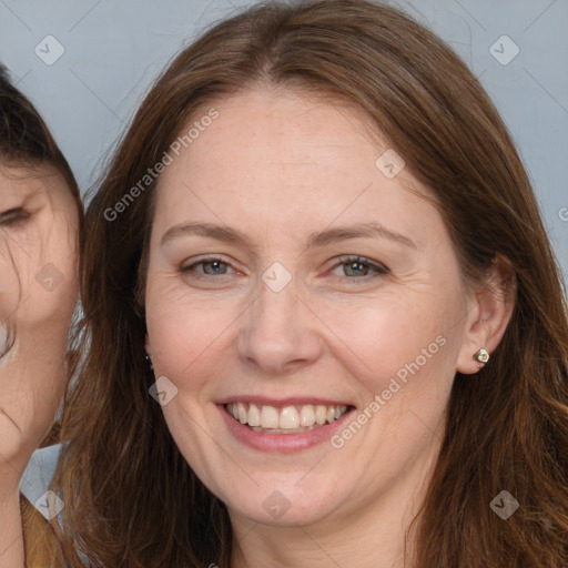 Joyful white adult female with long  brown hair and brown eyes