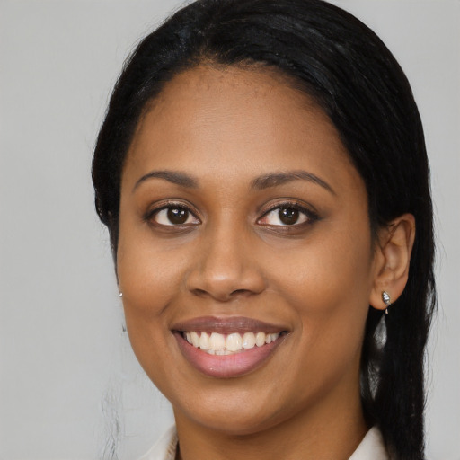 Joyful latino young-adult female with long  black hair and brown eyes