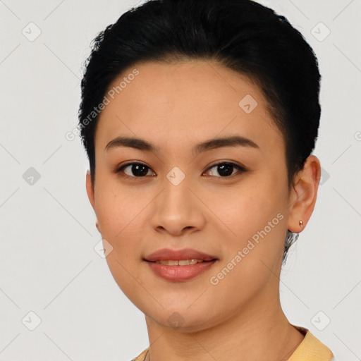 Joyful latino young-adult female with short  black hair and brown eyes