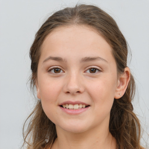 Joyful white child female with long  brown hair and brown eyes