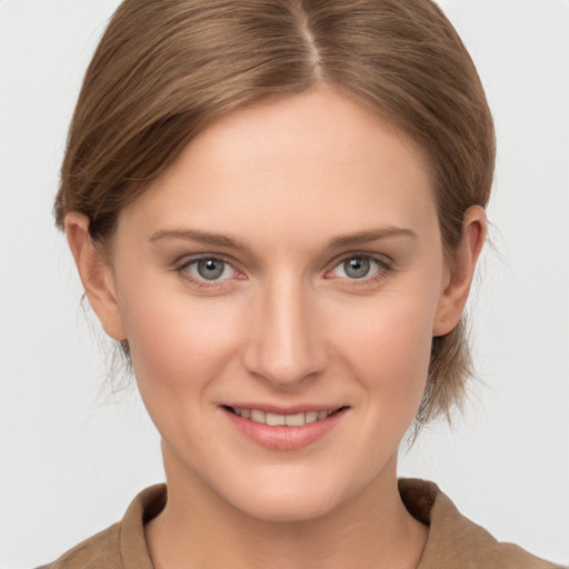 Joyful white young-adult female with medium  brown hair and grey eyes