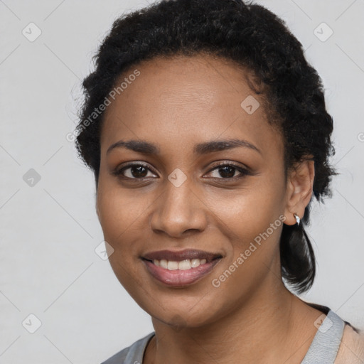 Joyful black young-adult female with short  black hair and brown eyes