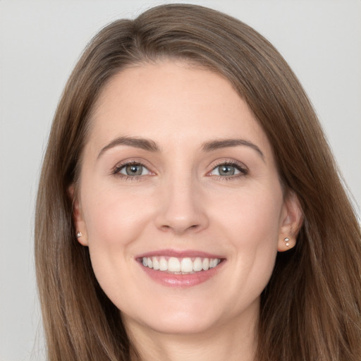 Joyful white young-adult female with long  brown hair and brown eyes