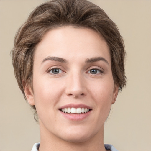 Joyful white young-adult female with short  brown hair and grey eyes