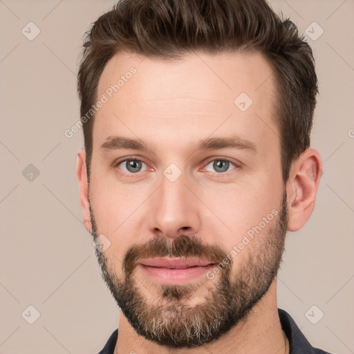 Joyful white young-adult male with short  brown hair and brown eyes