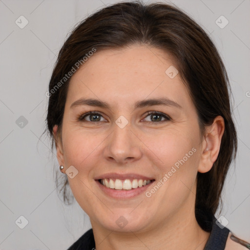 Joyful white young-adult female with medium  brown hair and brown eyes