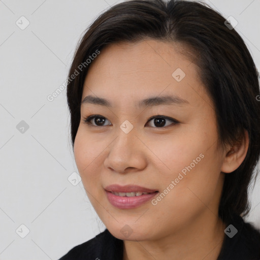 Joyful asian young-adult female with medium  brown hair and brown eyes