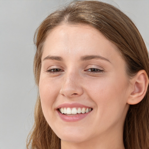 Joyful white young-adult female with long  brown hair and grey eyes