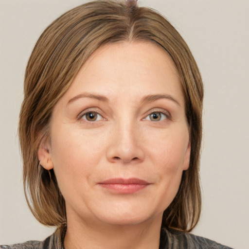 Joyful white adult female with medium  brown hair and grey eyes