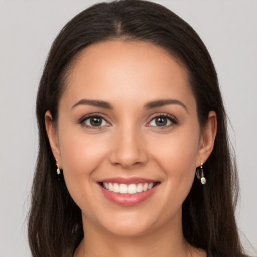 Joyful white young-adult female with long  brown hair and brown eyes