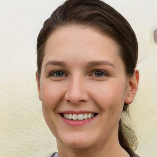 Joyful white young-adult female with short  brown hair and grey eyes