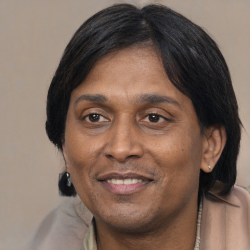 Joyful latino adult male with medium  brown hair and brown eyes