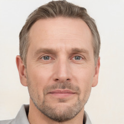 Joyful white adult male with short  brown hair and grey eyes