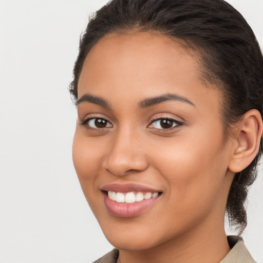 Joyful latino young-adult female with long  brown hair and brown eyes