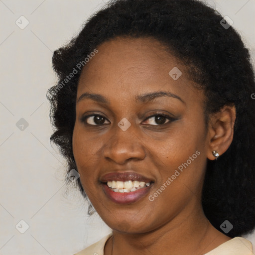 Joyful black young-adult female with long  black hair and brown eyes