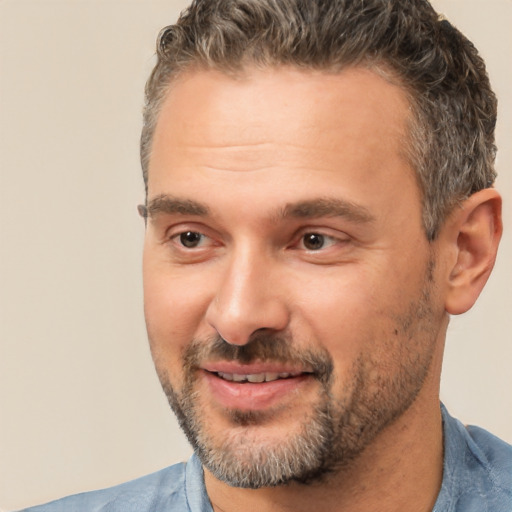 Joyful white adult male with short  brown hair and brown eyes