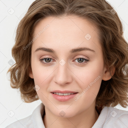 Joyful white young-adult female with medium  brown hair and blue eyes