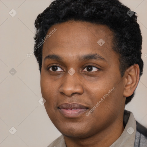 Joyful black young-adult male with short  black hair and brown eyes