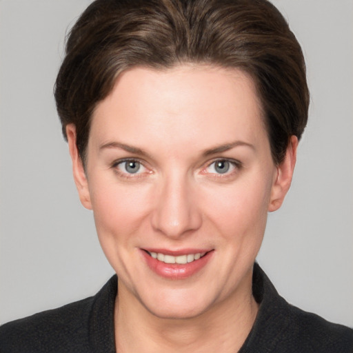 Joyful white young-adult female with short  brown hair and grey eyes