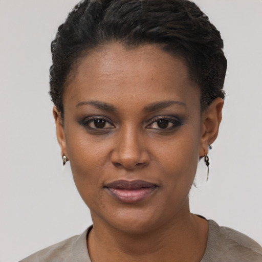 Joyful black young-adult female with short  brown hair and brown eyes