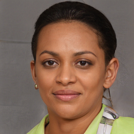 Joyful latino young-adult female with short  brown hair and brown eyes