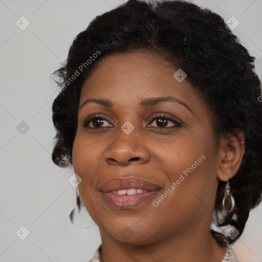 Joyful black adult female with medium  brown hair and brown eyes