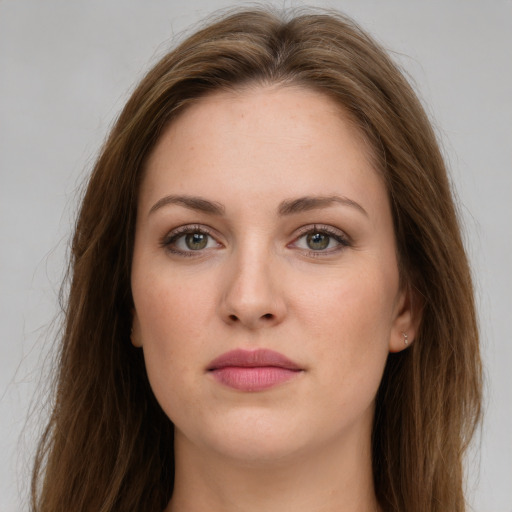 Joyful white young-adult female with long  brown hair and green eyes