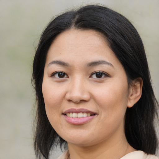 Joyful asian young-adult female with medium  brown hair and brown eyes