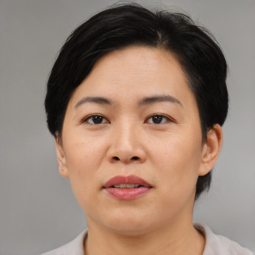 Joyful asian adult female with medium  black hair and brown eyes