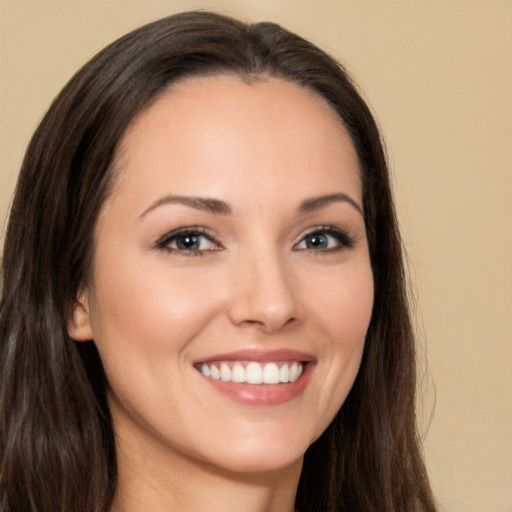 Joyful white young-adult female with long  brown hair and brown eyes