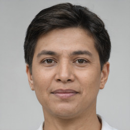 Joyful white adult male with short  brown hair and brown eyes