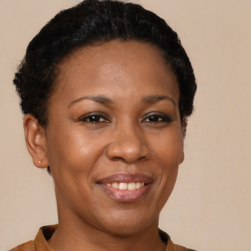 Joyful black young-adult female with short  black hair and brown eyes