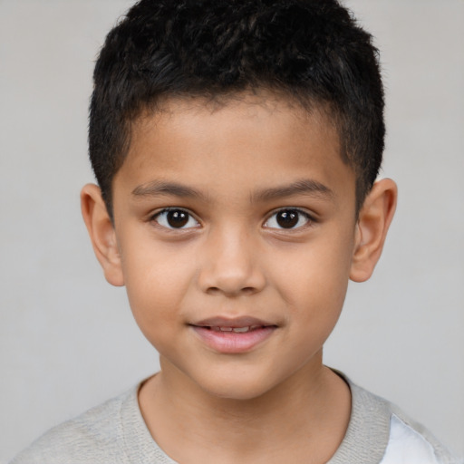 Joyful latino child male with short  brown hair and brown eyes