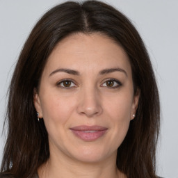 Joyful white adult female with medium  brown hair and brown eyes