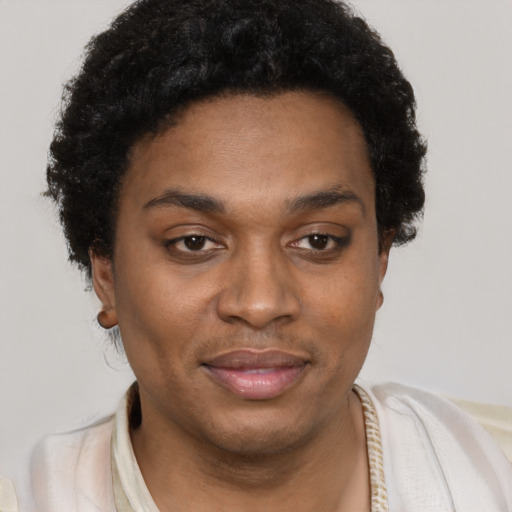 Joyful black young-adult female with short  black hair and brown eyes