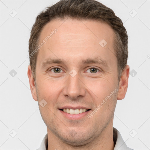 Joyful white adult male with short  brown hair and brown eyes