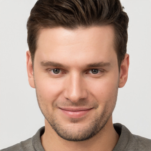 Joyful white young-adult male with short  brown hair and brown eyes