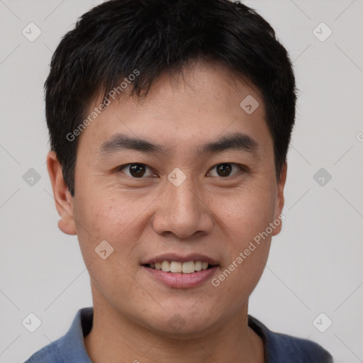 Joyful asian young-adult male with short  brown hair and brown eyes